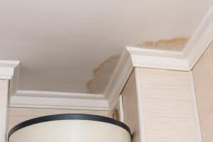 Neighbors have a water leak, water-damaged ceiling, close-up of a stain on the ceiling.